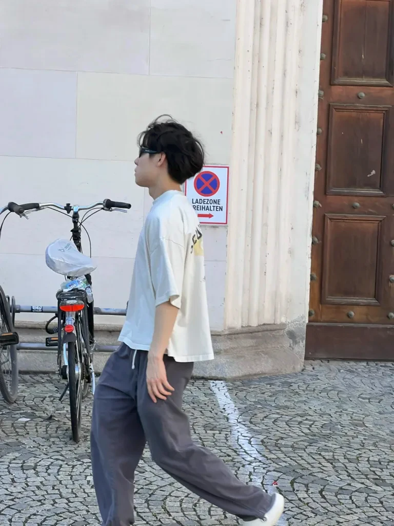 Me walking past a bike on a cobblestone street